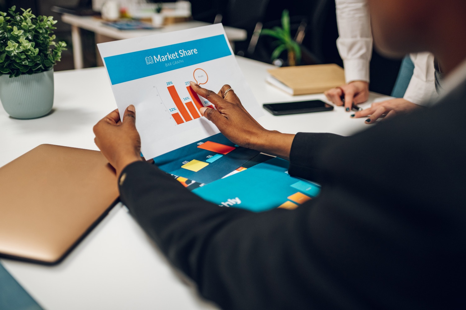 business colleagues discussing chart document duri 5VBWBHM