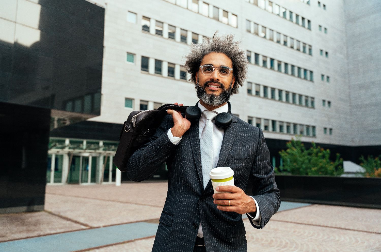 5 Key Elements of an Effective Business Strategy 1 young entrepreneur business man walking outside hi V26YUX8